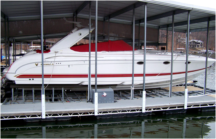Red and white boat docked on a boat lift