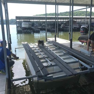 Two employees installing an Econo boat lift